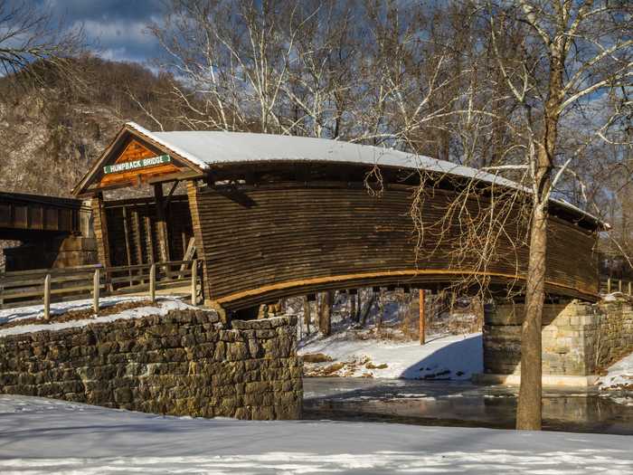 A quirky arch defines Humpback Covered Bridge in Covington, Virginia.