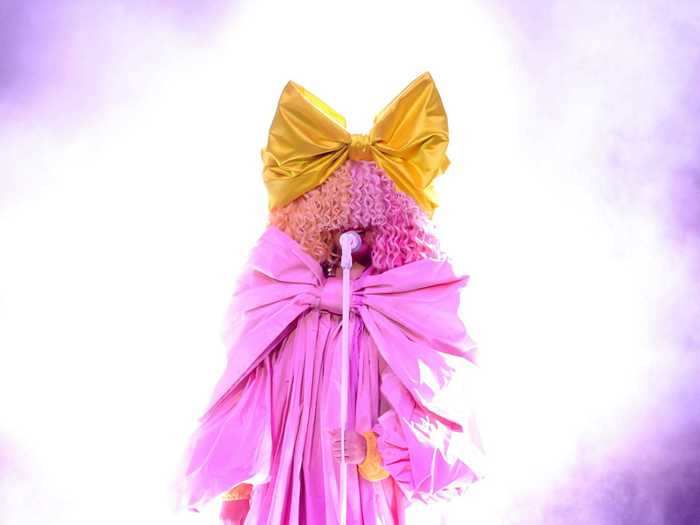 Sia brought a pop of color in this pink gown designed with a bow across the front.