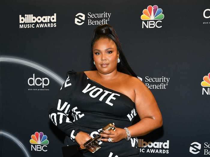 Lizzo made a statement in a "vote" minidress that was custom-made by Christian Siriano.