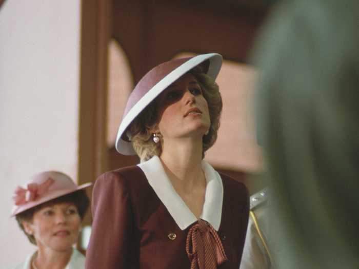 Princess Diana wore a wine-colored ensemble with a matching hat in October 1985.
