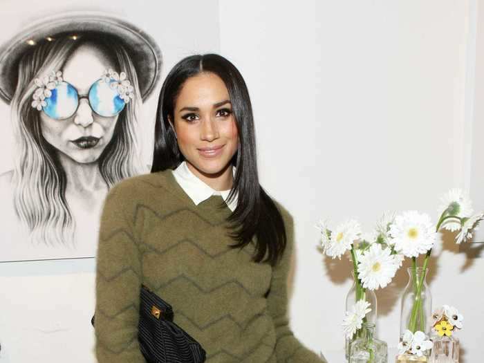 Meghan Markle wore this green sweater layered over a classic button-up in February 2014, but the look is perfect for the fall season.