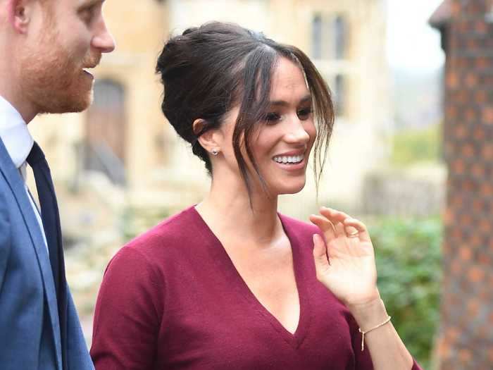 In October 2019, Markle paired a burgundy leather pencil skirt by Hugo Boss with a matching V-neck sweater.