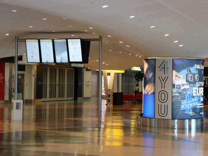 But for all the pre-security hustle and bustle, the interior of the terminal is still largely quiet with most non-essential businesses closed.