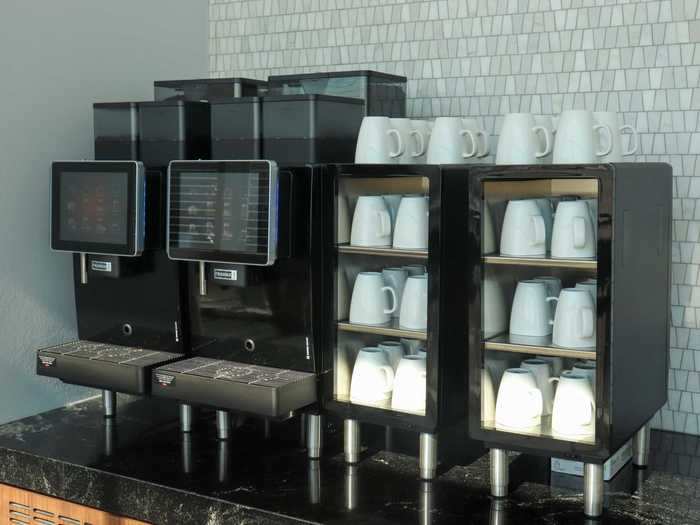 The lounge also features multiple full-service coffee machines with capabilities to make drinks like espresso, cappuccino, and hot chocolate.