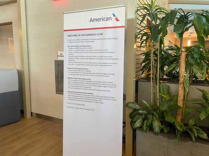 A large banner outside the lounge details the changes that visitors can expect, including the face mask requirement, revised food, and beverage offering, and capacity limits.