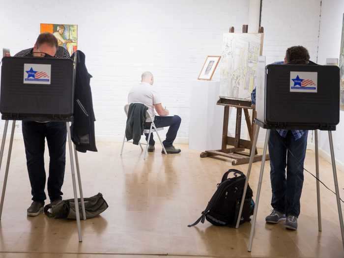A museum-goer observed artwork as people voted in the 2016 presidential election at the Swedish American Museum in Chicago, Illinois.