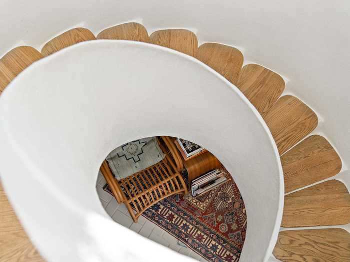 A spiral staircase connects the main level to the sleeping quarters below.