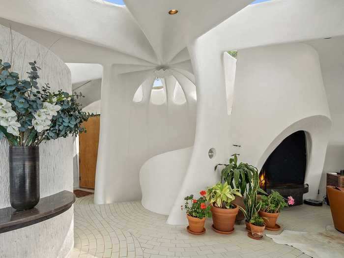 ... and tear-drop-shaped skylights flood the white-washed living area with natural light.