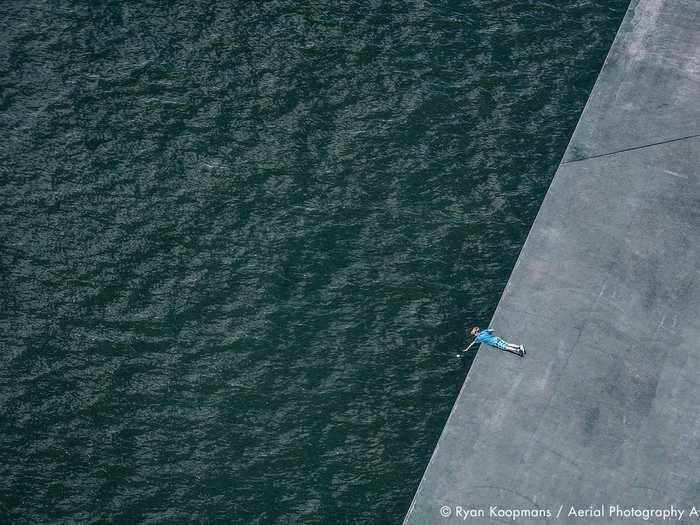 A child reaching over the edge of a body of water was the subject of Ryan Koopmans