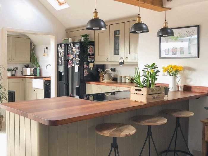 The kitchen has a number of industrial accents, like the lighting and barstools.