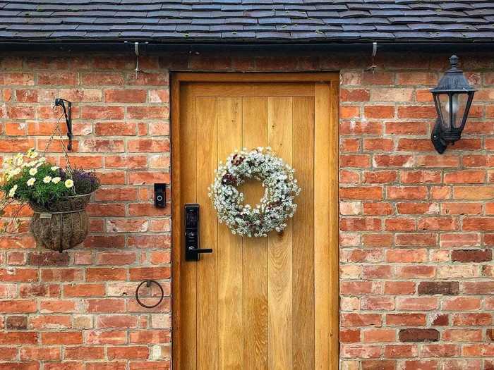 This quaint barn conversion in Staffordshire, United Kingdom, has a brick front and wooden door.