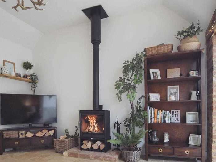 The home has cozy touches, like this wood burner fireplace.