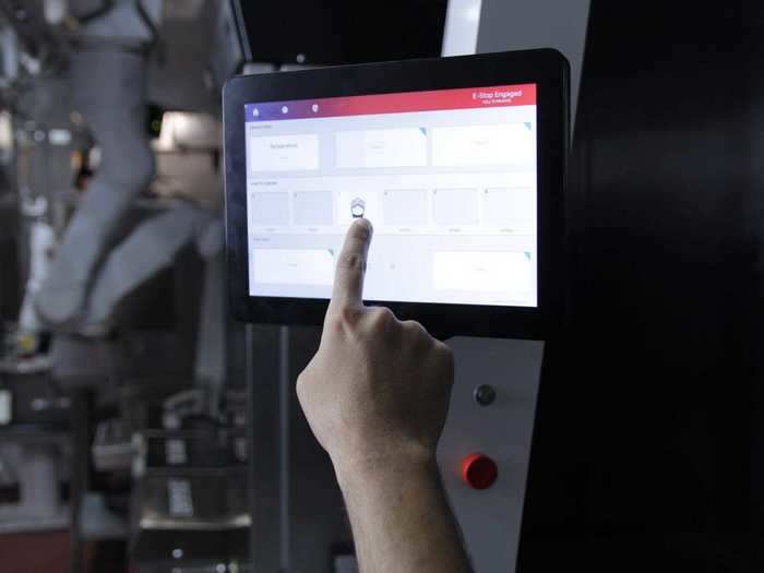 A monitor on the robot tells the staff what orders are up next, and staff can also adjust cooking times here for custom orders.