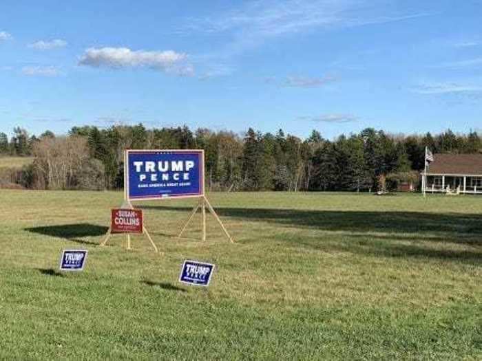 A massive Trump-Pence sign along with smaller Trump-Pence and Susan Collins campaign signs sit in front of a house in South Thomaston.