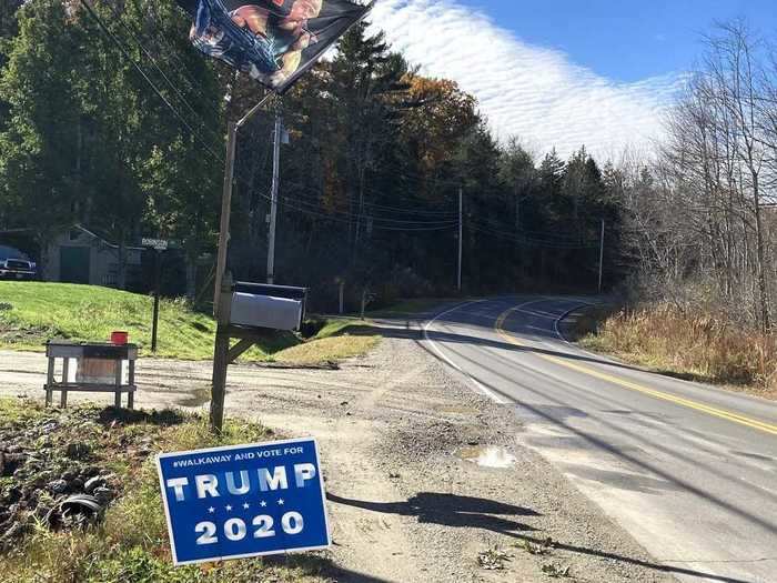 In Cushing, a Trump flag flies and a "#Walkaway and vote for Trump 2020" sign sits in the yard.