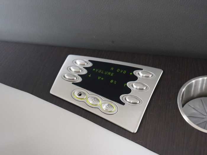 These panels at each seat controls the system with options for volume control and the video source, as well as the buttons to activate the overhead reading light and flight attendant call message.