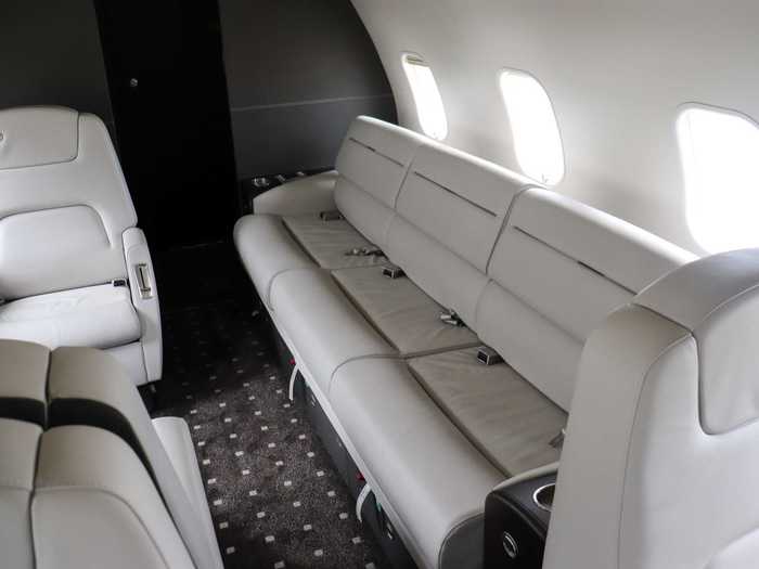 The divan adds three seats in the back, a common trick to increase the seat count on the plane and squeeze and additional passenger.