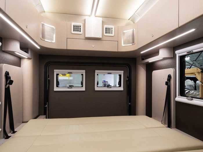 The camper has shoe storage shelves integrated into the side of the kitchen unit and cabinets that line most of the van