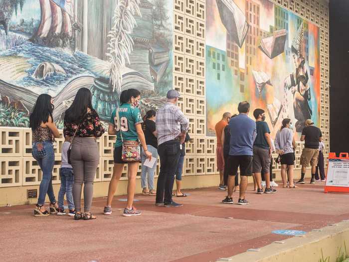 Early voters lined up in front of a mural at Hialeah Public Library in Florida on November 1, 2020.