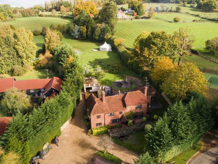 The manor-style home is roughly an hour southwest of London.