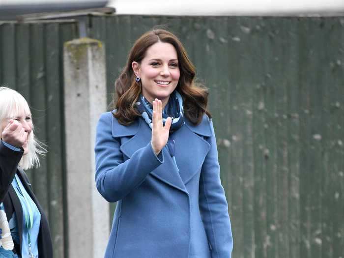 While visiting a school in London, Middleton wore a Sportmax coat with a Beulah London scarf.