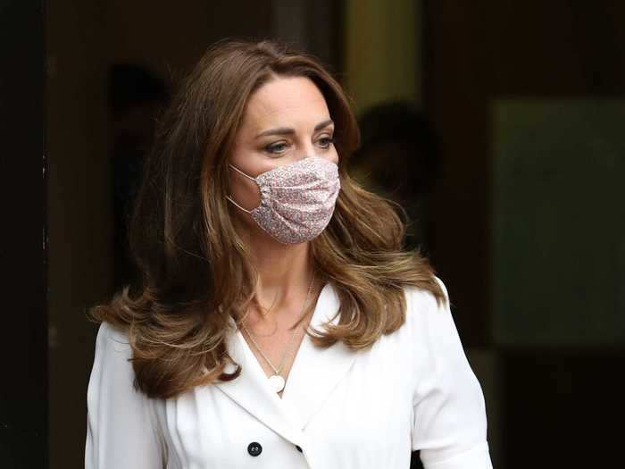 In August, she was photographed in a face mask for the first time, which she paired with a designer dress.