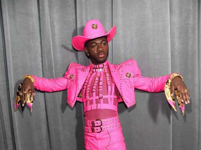 Lil Nas X attended the 2020 Grammys in a bright-pink outfit that included a harness, cropped leather jacket, cowboy hat, and matching scarves worn as bracelets.