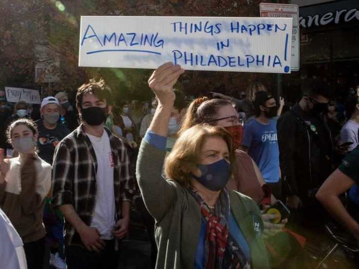 People held signs at a gathering in Philly on Saturday that reflected a collective spirit of hopefulness.