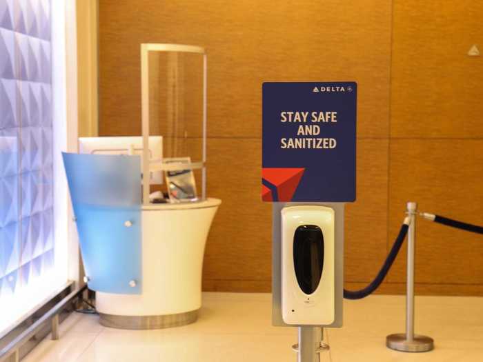 The very first sight as passengers walk in is that of a hand sanitizer dispenser, accompanied by two unused podiums with plexiglass partitions.