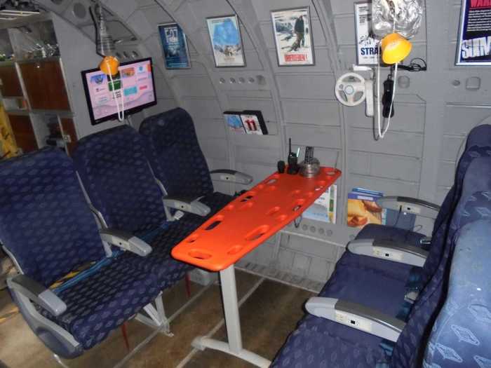 The former United Nations plane has been pretty much gutted with makeshift setups that include a lifeguard board surrounded by airline-style seats.