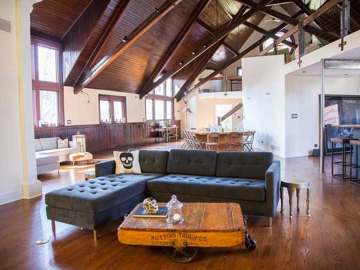 The pews that were once in front of the altar have been removed, and the space has been turned into an open floor concept.