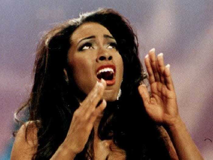 Kenya Moore was crowned Miss USA 1993 in an embellished white dress.