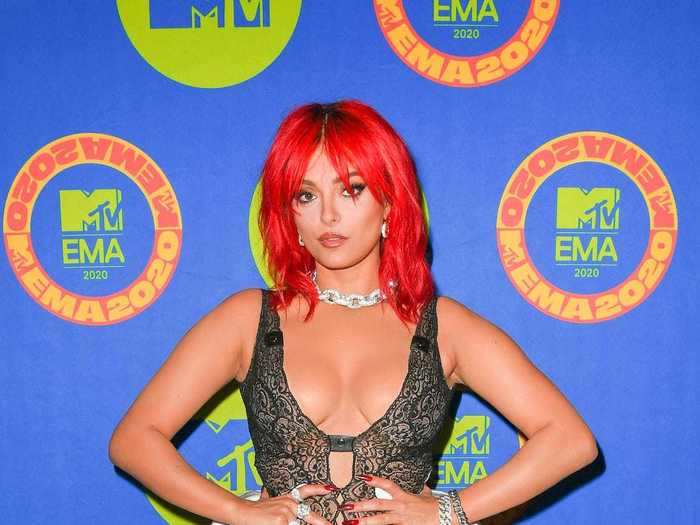 Bebe Rexha paired a lace minidress with leather boots and red hair.