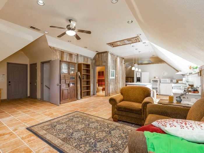 The listing also mentions a garage that fits four cars and a carriage house with its own bedroom and kitchen.