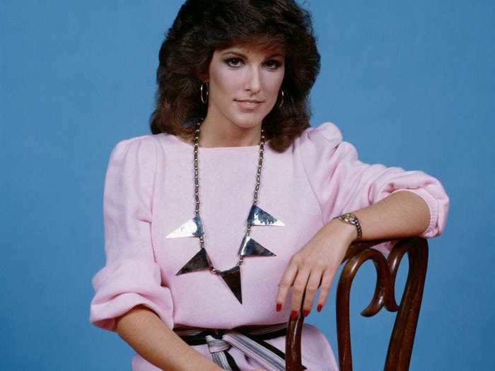 Charly McClain paired a pale pink dress with a striped belt and statement necklace in 1982.