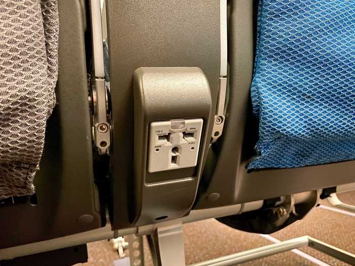 In-seat power is offered through a passenger-facing 110v AC power outlet and USB charging port.