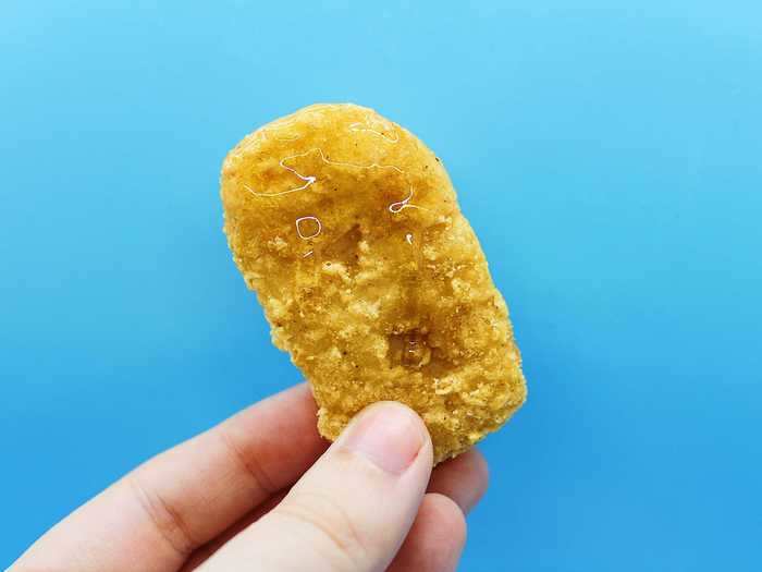 The honey glistened off the chicken nugget and smelled delicious.