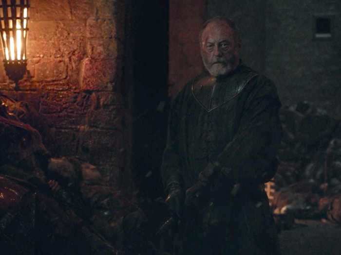 Davos was drawing a dagger so he could kill Melisandre before she allowed herself to die.