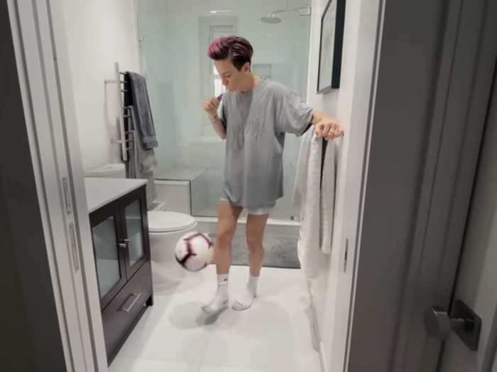 "Working from home" for the sports stars involved Megan juggling a soccer ball in their bathroom (which appears to have a large, luxurious shower in the back).