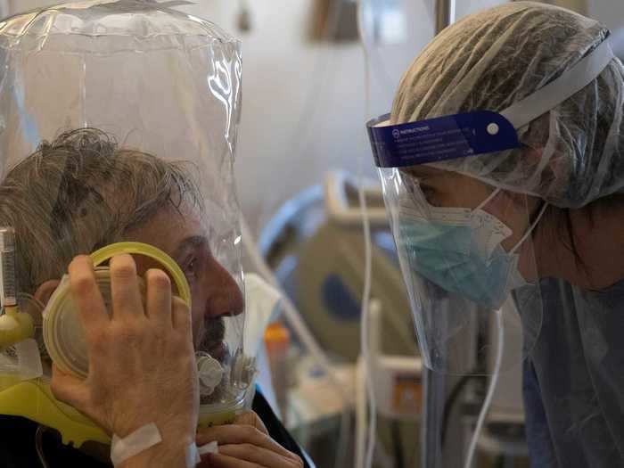 November 7: A patient and a doctor communicated through layers of protective gear in Rome.