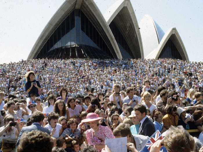 A photo taken one week after their arrival in Australia shows Diana outside of the Sydney Opera House surrounded by throngs of spectators.