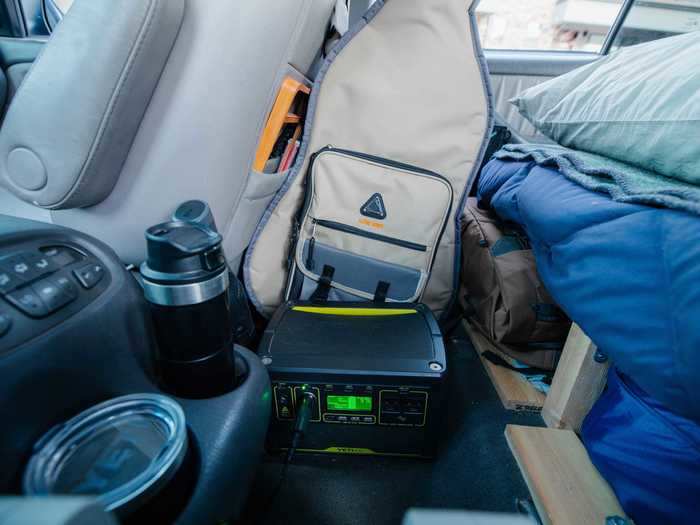 The battery bank is placed next to the refrigerator and charges as Wise drives.