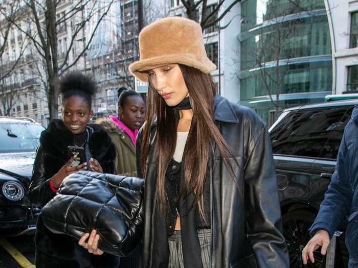 Hadid sported a furry bucket hat, which she paired with an oversized leather jacket and pinstriped pants.