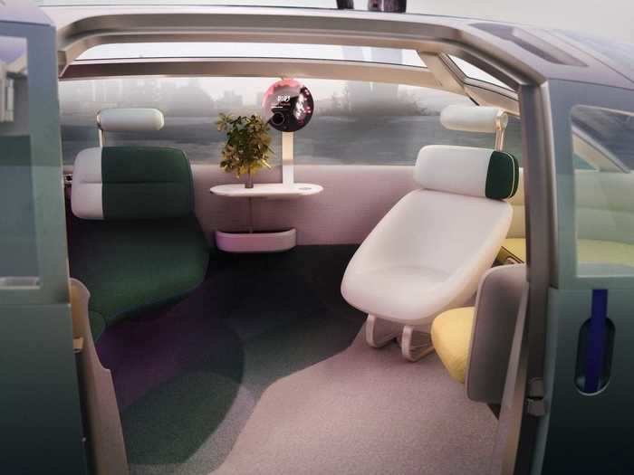 The table that the plant sits on is the "center point" for social interactions inside the vehicle. Near the table is a multi-purpose display that also doubles as a table lamp when it