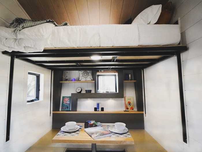 There are two beds for the four people: one lofted queen bed that can be electronically raised or lowered, and another bed that converts into a banquette-style dining and work area.