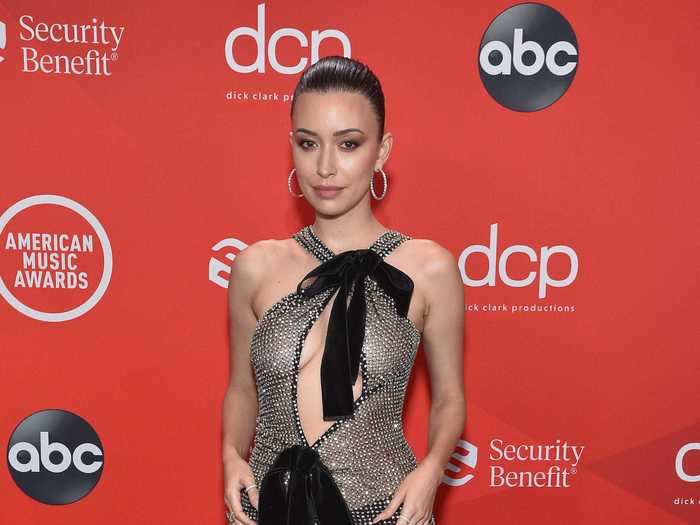 Christian Serratos embraced the see-through dress trend in a Tom Ford look.