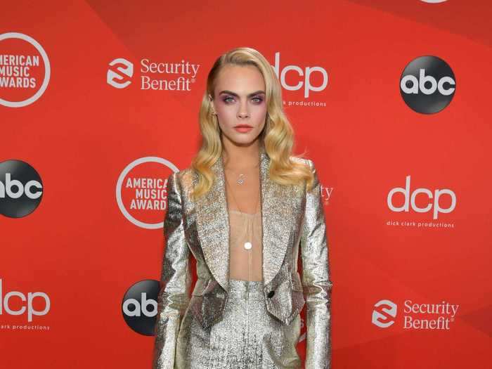 Cara Delevingne arrived at the awards show in a silver pantsuit.