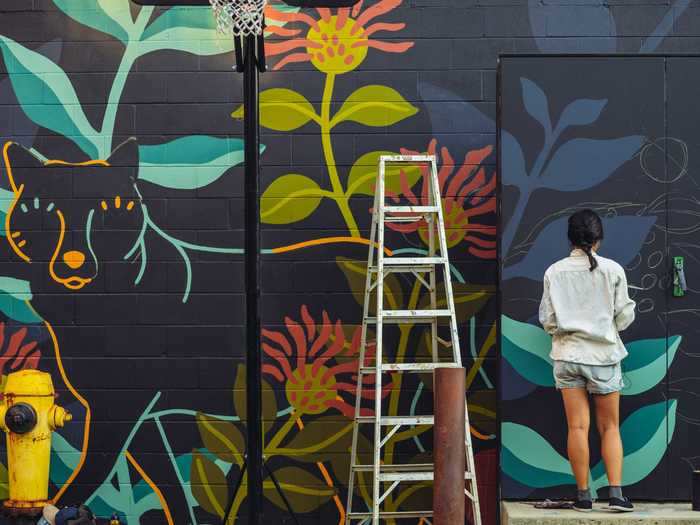 Paint a mural that will add vibrant visuals to a local community.