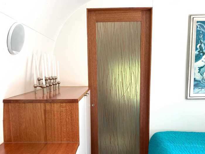 Amy appreciates how open the trailer feels. One way she and Ed achieved this effect is with this sliding barn door to the bathroom: The translucent panel filled with reeds allows light to shine into the bathroom while obscuring vision.