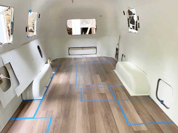 Once Ed had updated all the plumbing and wires, he mapped out where each utility would go on the floor in blue tape, and Amy began sourcing materials and fixtures.